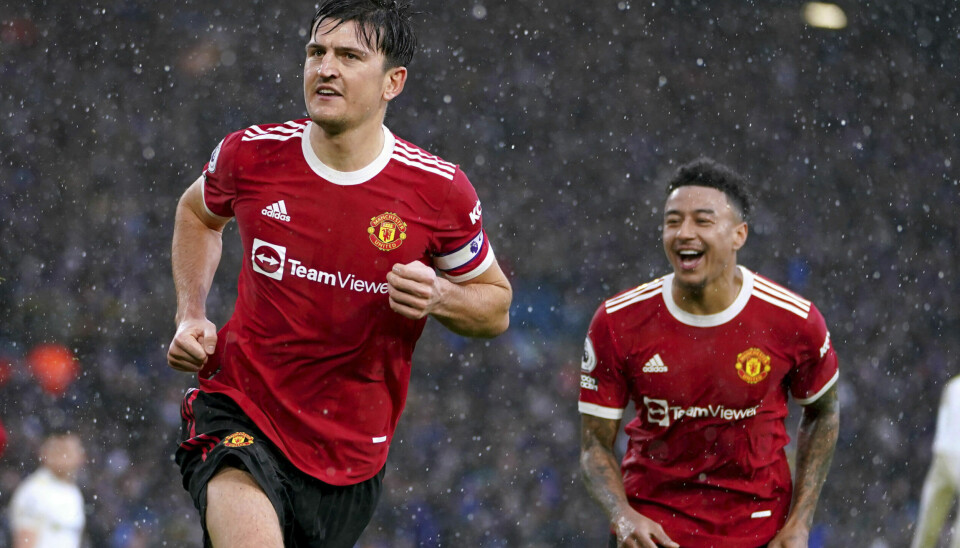 Manchester United's Harry Maguire, left,  celebrates after scoring his side's opening goal during the English Premier League soccer match between Leeds United and Manchester United, at Elland Road Stadium in Leeds, England, Sunday, Feb. 20, 2022. (Mike Egerton/PA via AP)