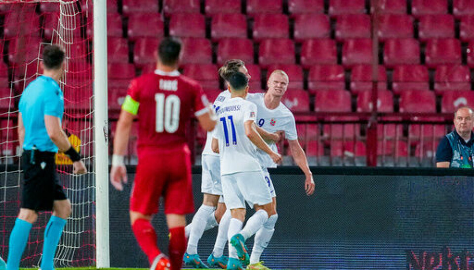 Erling Braut Haaland gratuleres med scoring mot Serbia, mens hjemmelagets kaptein Dusan Tadic fortviler