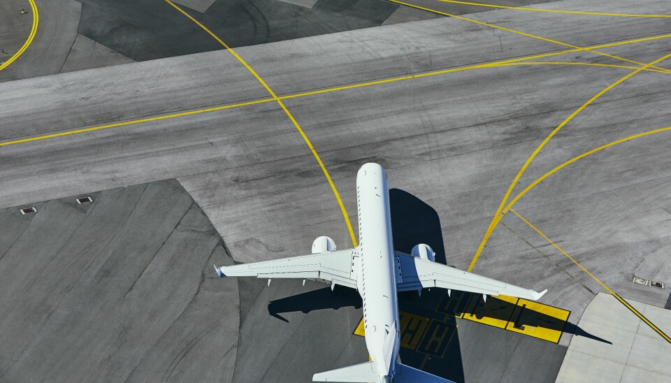 Aerial view of the airport. Airplane taxiing to runway.